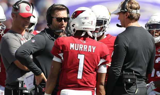 Head coach Kliff Kingsbury of the Arizona Cardinals talks with quarterback Kyler Murray #1 of the A...