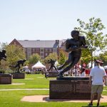 The University of Oklahoma displayed statues of five of its seven Heisman Trophy winners, tied for the most in college football, just outside its stadium. (Photo by Alex Simon/Cronkite News)
