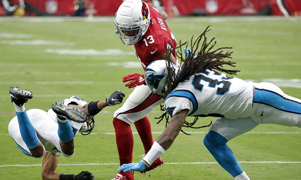 Arizona Cardinals wide receiver Christian Kirk (13) is hit by Carolina Panthers defensive back Tre ...