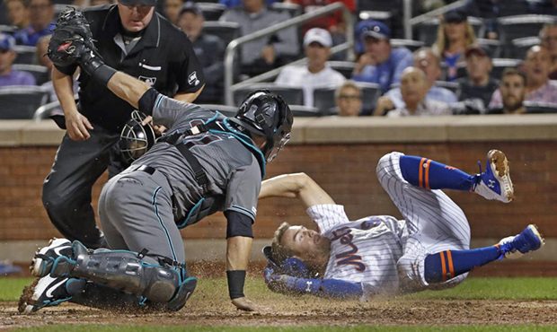 Arizona Diamondbacks catcher Alex Avila holds up the ball after tagging out New York Mets' Brandon ...