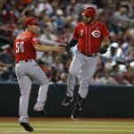 Cincinnati Reds' Eugenio Suarez celebrates with J.R. House (56) after hitting a solo home run in the sixth inning during a baseball game against the Arizona Diamondbacks, Sunday, Sept. 15, 2019, in Phoenix. (AP Photo/Rick Scuteri)