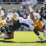 Michigan State's Cody White (7) is stopped by Arizona State's Erik Dickerson (93) and Evan Fields (4) during the first quarter of an NCAA college football game Saturday, Sept. 14, 2019, in East Lansing, Mich. (AP Photo/Al Goldis)