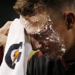 Arizona Diamondbacks' Jake Lamb wipes whipped cream off his face after getting a pie to the face from teammate Adam Jones after a baseball game win against the Miami Marlins, Monday, Sept. 16, 2019, in Phoenix. Lamb delivered a three-run double and the Diamondbacks defeated the Marlins 7-5. (AP Photo/Ross D. Franklin)