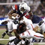 Arizona running back Darrius Smith, left, is tackled by Texas Tech defensive back Thomas Leggett (16) as he runs with the ball during the first half of an NCAA college football game, Saturday, Sept. 14, 2019, in Tucson, Ariz. (AP Photo/Ralph Freso)