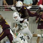 Arizona State wide receiver Brandon Aiyuk (2) leaps over Sacramento State defensive back Allen Perryman (30) during the first half of an NCAA college football game Friday, Sept. 6, 2019, in Tempe, Ariz. (AP Photo/Matt York)