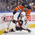 Arizona Coyotes defenseman Kyle Capobianco (75) chases the puck with Edmonton Oilers center Leon Draisaitl (29) during the second period of an NHL hockey preseason game Tuesday, Sept. 24, 2019, in Edmonton, Alberta. (Amber Bracken/The Canadian Press via AP)