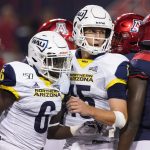 Northern Arizona running back Jacob Mpungi (6) celebrates with Case Cookus (15) after scoring a touchdown against Arizona in the second half during an NCAA college football game, Saturday, Sept. 7, 2019, in Tucson, Ariz. (AP Photo/Rick Scuteri)