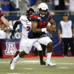 Arizona quarterback Khalil Tate (14) scrambles away from the Texas Tech defense during the second half of an NCAA college football game Saturday, Sept. 14, 2019, in Tucson, Ariz. (AP Photo/Ralph Freso)