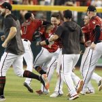 Arizona Diamondbacks players chase and grab teammate Tim Locastro after he hit the winning hit against the San Diego Padres during the ninth inning of a baseball game Sunday, Sept. 29, 2019, in Phoenix. (AP Photo/Darryl Webb)