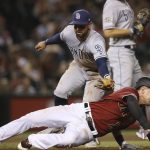 Arizona Diamondbacks' Nick Ahmed, bottom, gets tagged out in a rundown by San Diego Padres second baseman Greg Garcia, top, during the seventh inning of a baseball game Wednesday, Sept. 4, 2019, in Phoenix. The Diamondbacks won 4-1. (AP Photo/Ross D. Franklin)