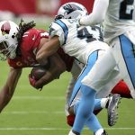 Arizona Cardinals wide receiver Larry Fitzgerald (11) is hit by Carolina Panthers defensive back Ross Cockrell during the first half of an NFL football game, Sunday, Sept. 22, 2019, in Glendale, Ariz. (AP Photo/Ross D. Franklin)