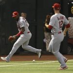 St. Louis Cardinals left fielder Marcell Ozuna, left, is unable to field a single hit by Arizona Diamondbacks' Jarrod Dyson as Cardinals shortstop Paul DeJong (12) looks on during the fifth inning of a baseball game, Monday, Sept. 23, 2019, in Phoenix. Ozuna earned a fielding error on the play. (AP Photo/Ross D. Franklin)