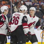 Arizona Coyotes center Barrett Hayton (29), right wing Christan Fischer (36) and defenseman Jakob Chychrun (6) celebrate a goal against the Edmonton Oilers during the first period of an NHL hockey preseason game Tuesday, Sept. 24, 2019, in Edmonton, Alberta. (Amber Bracken/The Canadian Press via AP)