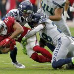 Arizona Cardinals wide receiver Christian Kirk (13) is tackled by Seattle Seahawks cornerback Akeem King (36) and cornerback Ugo Amadi (28) during the second half of an NFL football game, Sunday, Sept. 29, 2019, in Glendale, Ariz. (AP Photo/Rick Scuteri)