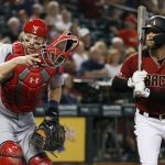 St. Louis Cardinals catcher Matt Wieters, left, looks for a wild pitch to Arizona Diamondbacks' Christian Walker, right, during the sixth inning of a baseball game Wednesday, Sept. 25, 2019, in Phoenix. (AP Photo/Ross D. Franklin)