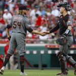 Arizona Diamondbacks relief pitcher Jimmie Sherfy, left, celebrates with catcher Carson Kelly, right, after closing the ninth inning of a baseball game, Saturday, Sept. 7, 2019, in Cincinnati. (AP Photo/John Minchillo)