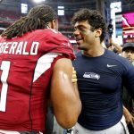 Arizona Cardinals wide receiver Larry Fitzgerald (11) greets Seattle Seahawks quarterback Russell Wilson after an NFL football game, Sunday, Sept. 29, 2019, in Glendale, Ariz. The Seahawks won 27-10. (AP Photo/Rick Scuteri)