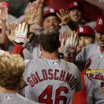 St. Louis Cardinals' Paul Goldschmidt (46) is greeted by teammates in the dugout after hitting a solo home run against the Arizona Diamondbacks during the 13th inning of a baseball game, Tuesday, Sept. 24, 2019, in Phoenix. (AP Photo/Matt York)