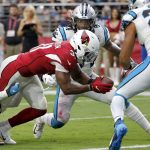 Arizona Cardinals running back David Johnson (31) scores a touchdown as Carolina Panthers strong safety Eric Reid (25) and outside linebacker Shaq Thompson (54) defend during the second half of an NFL football game, Sunday, Sept. 22, 2019, in Glendale, Ariz. (AP Photo/Ross D. Franklin)