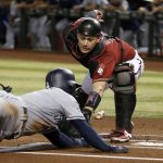 Arizona Diamondbacks catcher Carson Kelly, right, tags out San Diego Padres' Greg Garcia at home during the first inning of a baseball game Wednesday, Sept. 4, 2019, in Phoenix. (AP Photo/Ross D. Franklin)