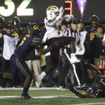 Arizona State's Eno Benjamin (3) jumps over California's Elijah Hicks as he is pursued by Jaylinn Hawkins in the second half of an NCAA college football game, Friday, Sept. 27, 2019, in Berkeley, Calif. (AP Photo/Ben Margot)