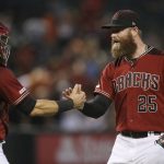 Arizona Diamondbacks relief pitcher Archie Bradley (25) slaps hands with catcher Alex Avila after the final out of the team's baseball game against the St. Louis Cardinals on Wednesday, Sept. 25, 2019, in Phoenix. The Diamondbacks won 9-7. (AP Photo/Ross D. Franklin)