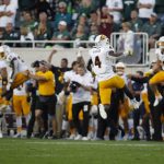 Arizona State players, including Evan Fields (4), celebrate at the conclusion of a win over Michigan State in an NCAA college football game, Saturday, Sept. 14, 2019, in East Lansing, Mich. (AP Photo/Al Goldis)