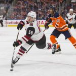 Arizona Coyotes left wing Michael Bunting (58) shoots under pressure from Edmonton Oilers defenseman Darnell Nurse (25) during the first period of an NHL hockey preseason game Tuesday, Sept. 24, 2019, in Edmonton, Alberta. (Amber Bracken/The Canadian Press via AP)