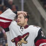 Arizona Coyotes goaltender Adin Hill wipes sweat from his forehead during a break in play during the second period of the team's NHL hockey preseason game against the Edmonton Oilers on Tuesday, Sept. 24, 2019, in Edmonton, Alberta. (Amber Bracken/The Canadian Press via AP)