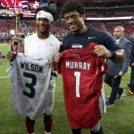 Seattle Seahawks quarterback Russell Wilson, right, and Arizona Cardinals quarterback Kyler Murray, left, exchange jerseys after an NFL football game, Sunday, Sept. 29, 2019, in Glendale, Ariz. (AP Photo/Ross D. Franklin)