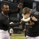 Arizona Diamondbacks' Adam Jones, left, gets Diamondbacks' Jake Lamb, right, with a pie in the face as the two celebrate Lamb's three-run home run against the San Diego Padres, from the eighth inning, after a baseball game, Friday, Sept. 27, 2019, in Phoenix. The Diamondbacks defeated the Padres 6-3. (AP Photo/Ross D. Franklin)