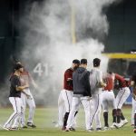 Arizona Diamondbacks players chase Tim Locastro and give him a baby powder shower after getting the game-winning hit against the San Diego Padres during the ninth inning of a baseball game, Sunday, Sept. 29, 2019, in Phoenix. (AP Photo/Darryl Webb)