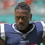 In this Sunday, Sept. 15, 2019, photo, New England Patriots wide receiver Antonio Brown waits for the team's NFL football game against the Miami Dolphins to begin in Miami Gardens, Fla. Brown was released by the Patriots on Friday, Sept. 20, after a second woman accused him of sexual misconduct. (David Santiago/Miami Herald via AP)