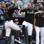 Arizona Diamondbacks' Christian Walker (53) celebrates with teammate Ketel Marte after hitting a solo home run against the San Diego Padres during the second inning of a baseball game, Saturday, Sept. 28, 2019, in Phoenix. (AP Photo/Ralph Freso)