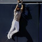 San Diego Padres center fielder Manuel Margot leaps to catch a ball at the fence hit by Arizona Diamondbacks Christian Walker during the seventh inning of a baseball game in San Diego, Sunday, Sept. 22, 2019. (AP Photo/Alex Gallardo)
