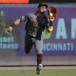 Arizona Diamondbacks third baseman Josh Rojas catches out Cincinnati Reds' Aristides Aquino in the seventh inning of a baseball game, Saturday, Sept. 7, 2019, in Cincinnati. (AP Photo/John Minchillo)