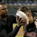 Arizona Diamondbacks' Jake Lamb, right, gets a pie in the face from teammate Adam Jones after a baseball game win against the Miami Marlins, Monday, Sept. 16, 2019, in Phoenix. Lamb delivered a three-run double and the Diamondbacks defeated the Marlins 7-5. (AP Photo/Ross D. Franklin)
