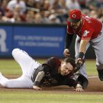 Cincinnati Reds third baseman Eugenio Suarez (7) tags out Arizona Diamondbacks' Wilmer Flores trying to advance a base on a ball hit by Ketel Marte in the third inning during a baseball game, Sunday, Sept. 15, 2019, in Phoenix. (AP Photo/Rick Scuteri)