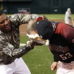 Arizona Diamondbacks' Christian Walker (53) is hit in the face with a pie by teammate Adam Jones following 6-5 victory against the San Diego Padres during a baseball game, Saturday, Sept. 28, 2019, in Phoenix. Walker hit the go-ahead grand slam home run in the seventh inning. (AP Photo/Ralph Freso)
