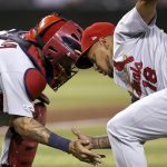 St. Louis Cardinals relief pitcher Carlos Martinez (18) celebrates the team's 9-7 victory with catcher Yadier Molina after the final out of a baseball game against the Arizona Diamondbacks, Monday, Sept. 23, 2019, in Phoenix. (AP Photo/Ross D. Franklin)
