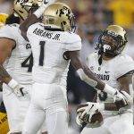 Colorado safety Derrion Rakestraw, right, celebrates with Nu'umotu Falo Jr. and Jordan Clark (1) after intercepting the ball on a pass from Arizona State quarterback Jayden Daniels in the second half during an NCAA college football game, Saturday, Sept. 21, 2019, in Tempe, Ariz. Colorado defeated Arizona State 34-31. (AP Photo/Rick Scuteri)