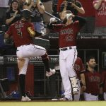 Arizona Diamondbacks' Ketel Marte (4) celebrates his grand slam against the San Diego Padres with Christian Walker (53) during the seventh inning of a baseball game Wednesday, Sept. 4, 2019, in Phoenix. (AP Photo/Ross D. Franklin)