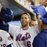 New York Mets' Jeff McNeil (6) is congratulated in the dugout after hitting a solo home run during the second inning of the team's baseball game against the Arizona Diamondbacks, Wednesday, Sept. 11, 2019, in New York. (AP Photo/Kathy Willens)