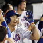 New York Mets' Brandon Nimmo is congratulated in the dugout after hitting a solo home run during the first inning of the team's baseball game against the Arizona Diamondbacks, Wednesday, Sept. 11, 2019, in New York. (AP Photo/Kathy Willens)