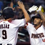 Arizona Diamondbacks' Ketel Marte, right, celebrates with Josh Rojas (9) after hitting a two-run home run in the second inning during a baseball game against the San Diego Padres, Monday, Sept. 2, 2019, in Phoenix. (AP Photo/Rick Scuteri)