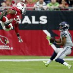 Seattle Seahawks wide receiver Tyler Lockett (16) makes the catch as Arizona Cardinals strong safety Budda Baker (32) defends during the first half of an NFL football game, Sunday, Sept. 29, 2019, in Glendale, Ariz. (AP Photo/Rick Scuteri)