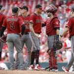 Arizona Diamondbacks relief pitcher Yoan Lopez, center, waits to be relieved by manager Torey Lovullo (17) in the ninth inning of a baseball game against the Cincinnati Reds, Sunday, Sept. 8, 2019, in Cincinnati. (AP Photo/John Minchillo)