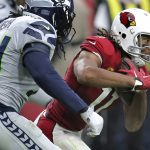 Arizona Cardinals wide receiver Larry Fitzgerald (11) runs as Seattle Seahawks defensive end Ezekiel Ansah defends during the second half of an NFL football game, Sunday, Sept. 29, 2019, in Glendale, Ariz. (AP Photo/Ross D. Franklin)