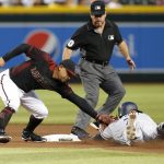 Arizona Diamondbacks second baseman Eduardo Escobar, left, tags out San Diego Padres' Manuel Margot, right, as he tries to steal during the fourth inning of a baseball game, Saturday, Sept. 28, 2019, in Phoenix. (AP Photo/Ralph Freso)