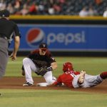 Cincinnati Reds' Phillip Ervin (6) is tagged out by Arizona Diamondbacks shortstop Nick Ahmed while trying to steal second base in the seventh inning during a baseball game Sunday, Sept. 15, 2019, in Phoenix. (AP Photo/Rick Scuteri)